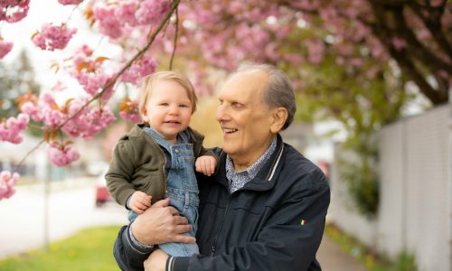 a man holding a little boy in his arms