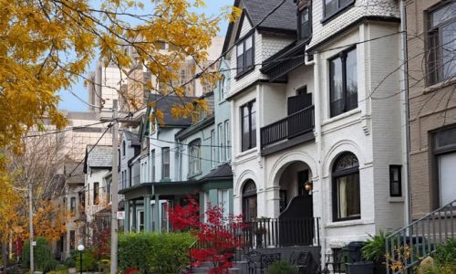 street of  old Victorian houses with gables and painted brick