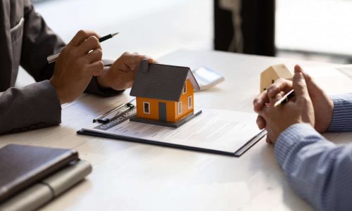Real estate agent discuss about the terms of the home purchase agreement and asked the customer to sign the documents to make the contract legally, Home sales, lease, mortgage and home insurance.